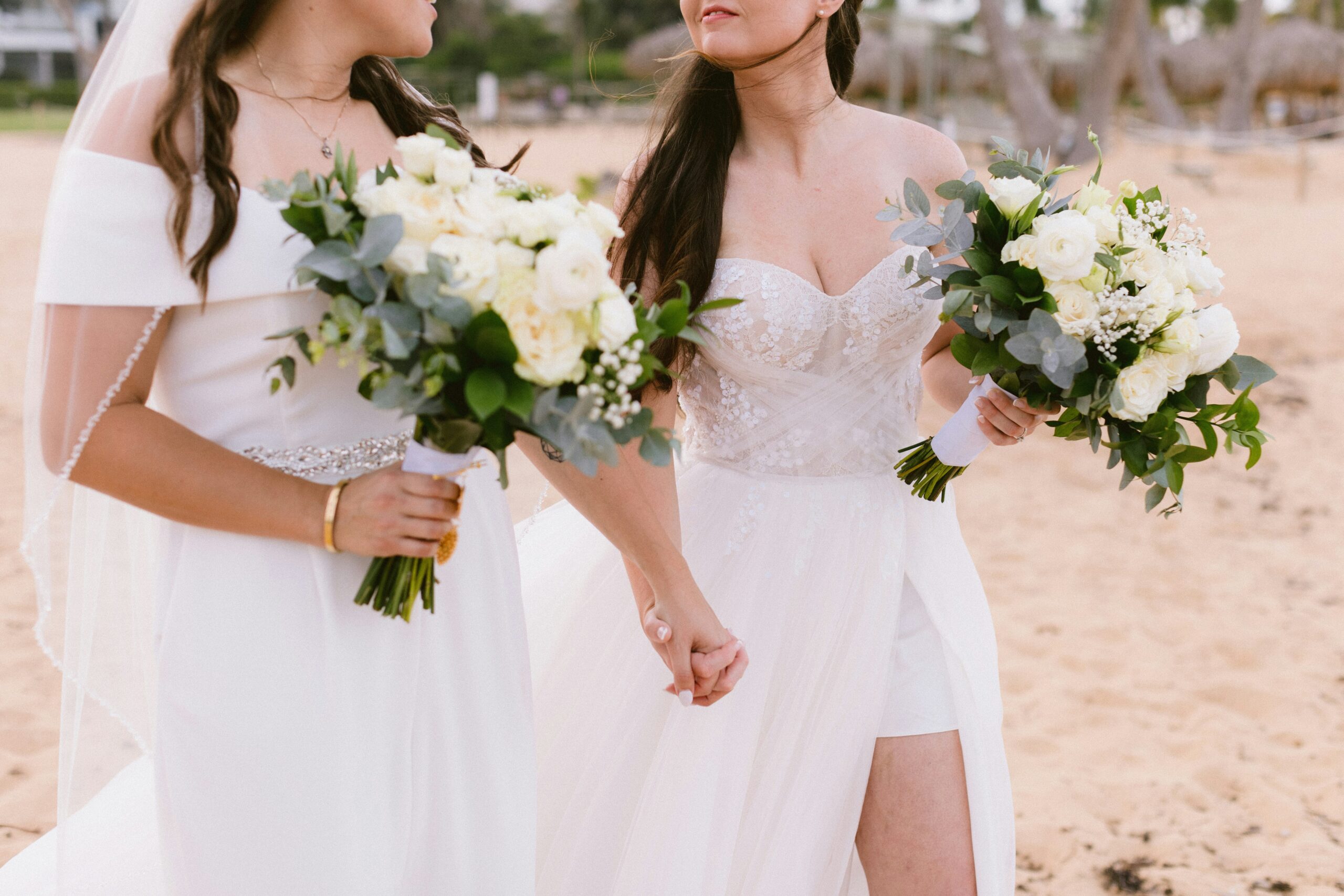 Two brides on the beach in white dresses