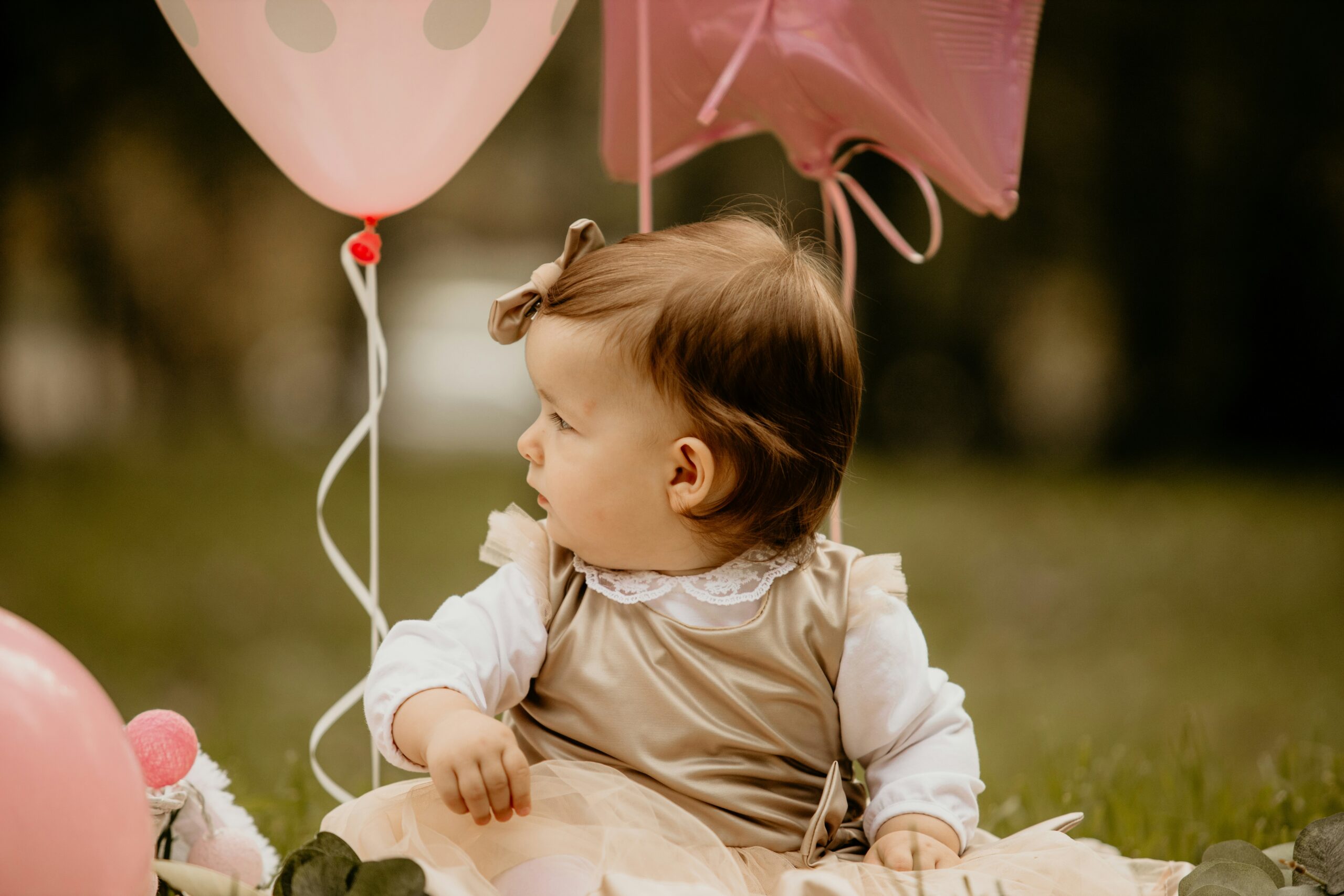 Baby with pink balloons