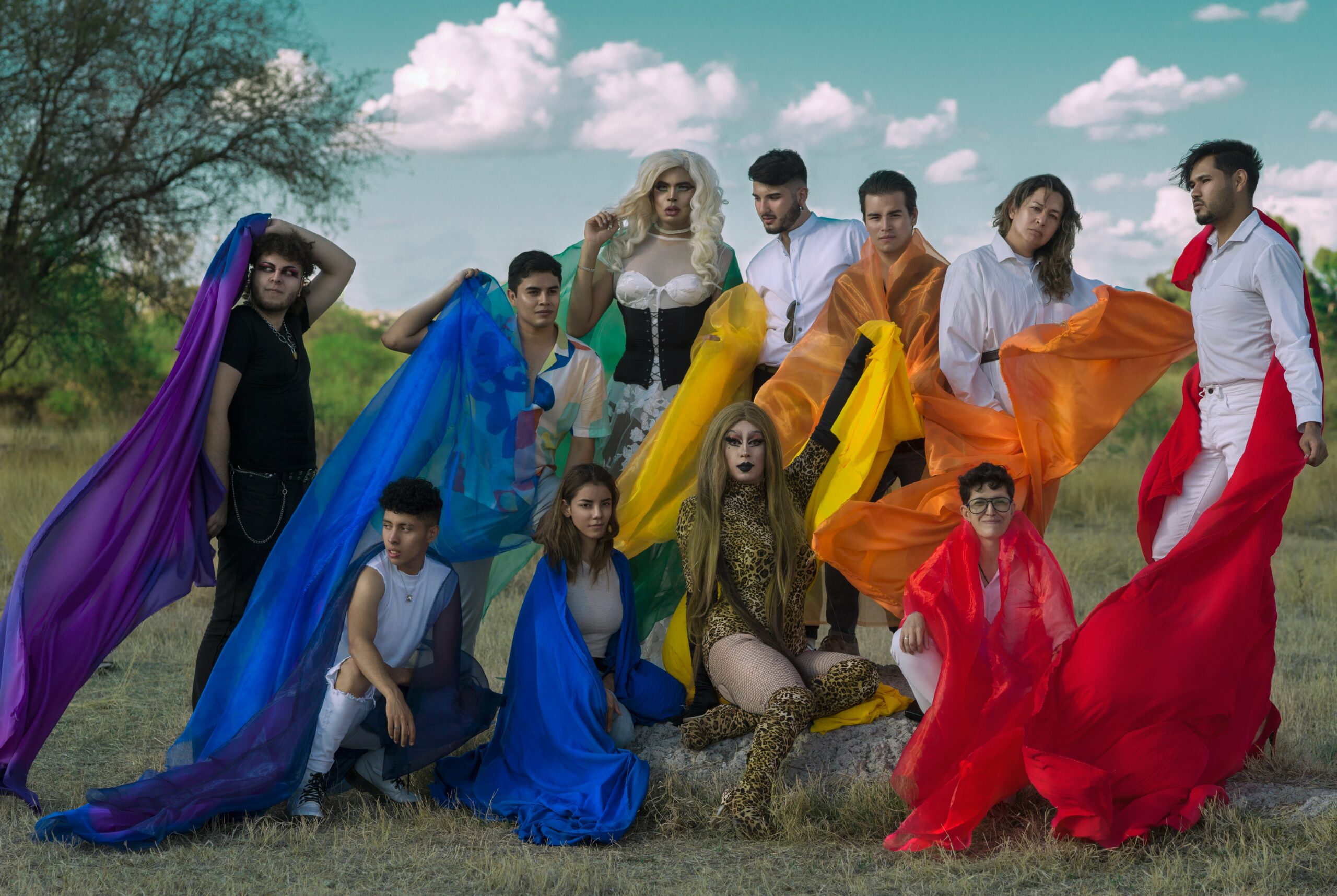 Group of queer people with rainbow flags