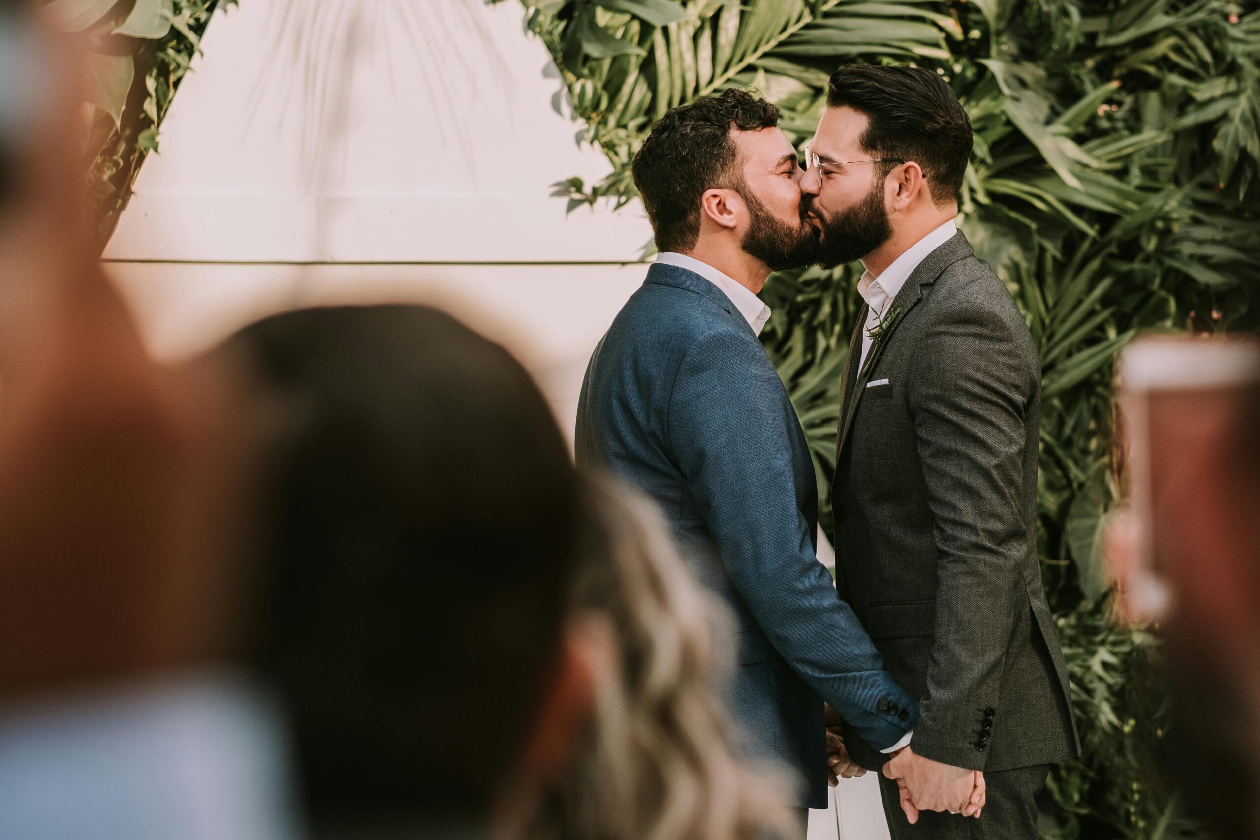 Gay couple kissing at their wedding